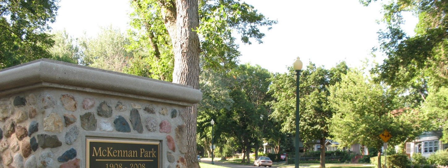 The park's stone nameplate sign with lilies, the master plan's cover photograph